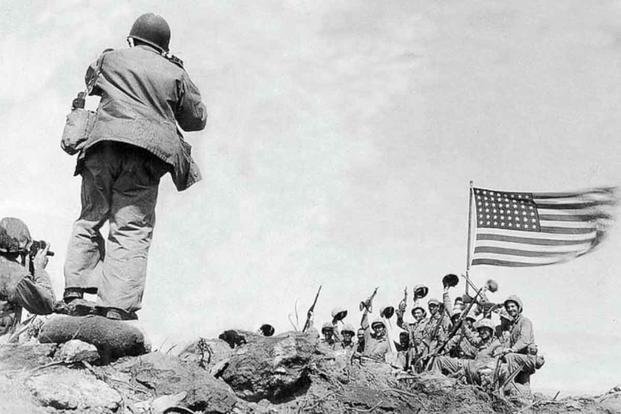 Marine Corps Sgt. Bill Genaust, left, and Joe Rosenthal photograph U.S. Marines at the second flag-raising on Iwo Jima during World War II, Feb. 23, 1945. (U.S. Marine Corps/Bob Campbell)