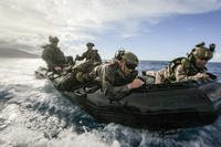 Marines hold on for a bumpy ride on a combat rubber raiding craft during a training exercise off the coast of the Philippines.
